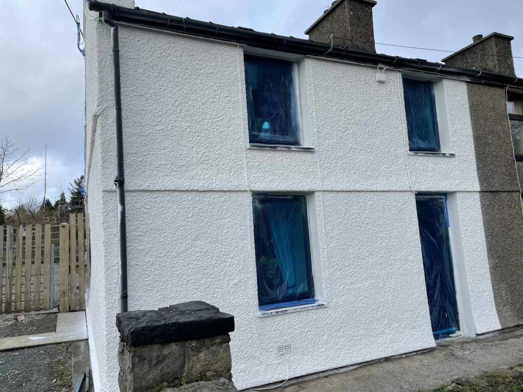 Exterior Pebble dash house newly spray painted image